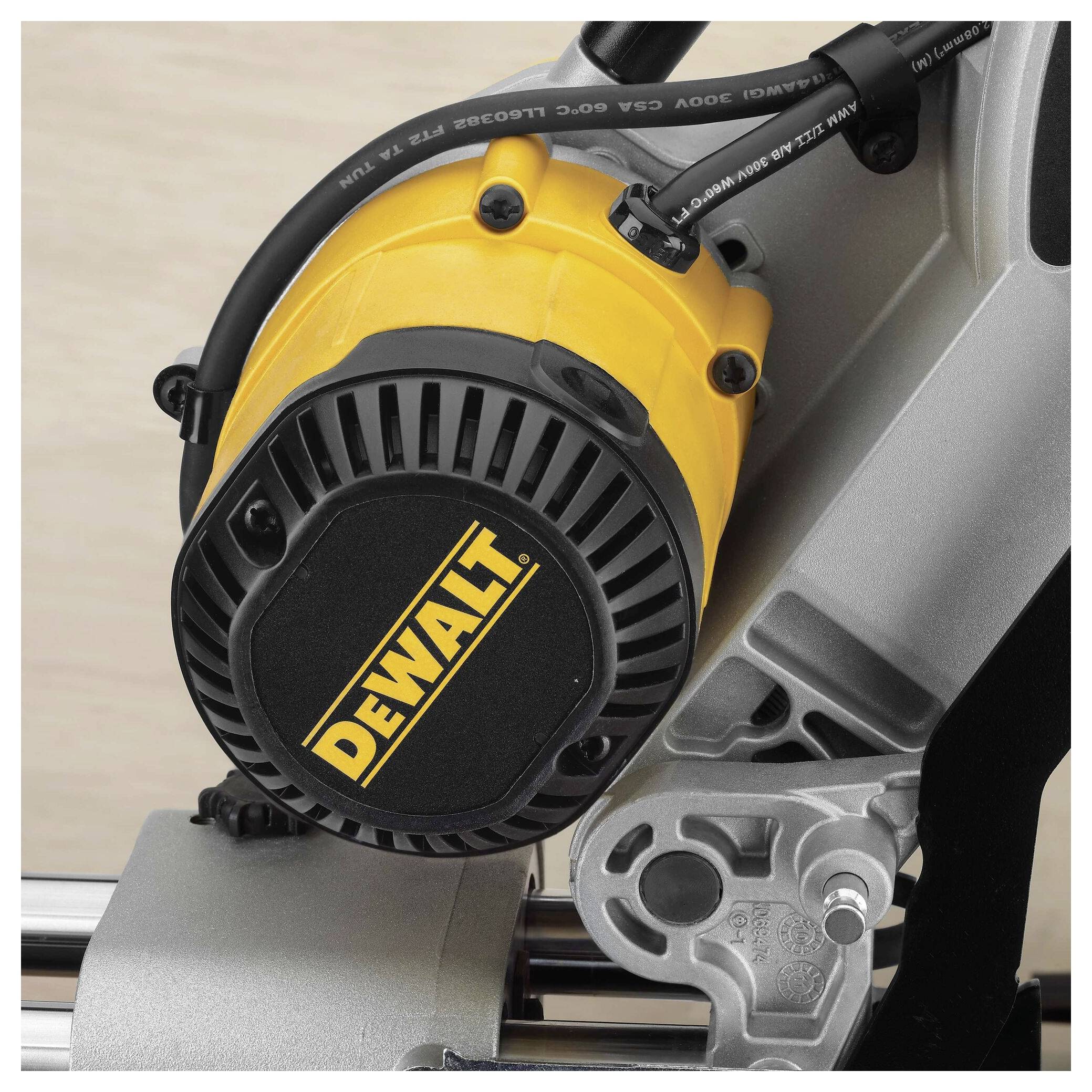 Power tool with 'DEWALT' branding on a motor; metal assembly visible.
