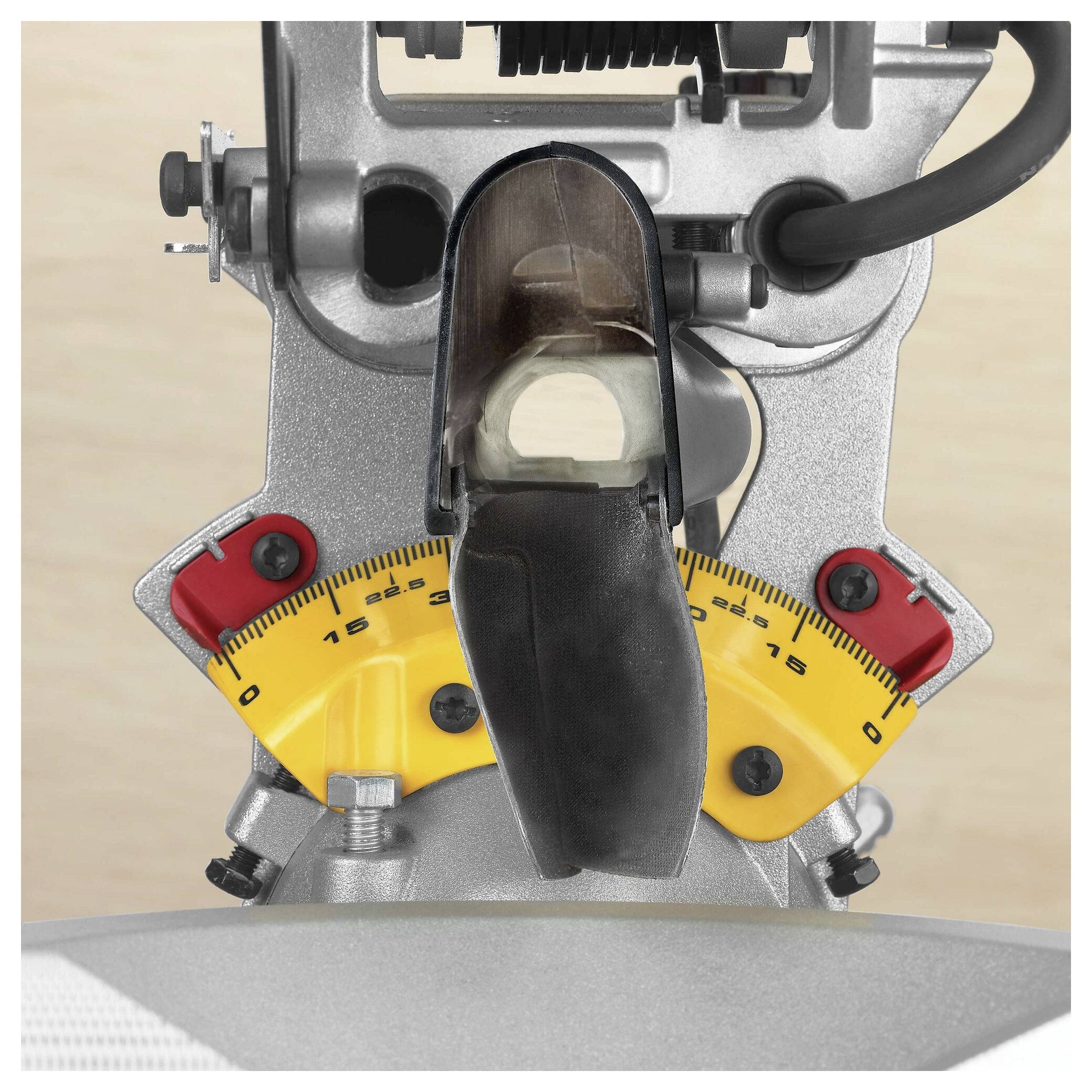 A close-up image of a miter saw's angle gauge, showing yellow and red sections with degree markings for precise angle adjustments.