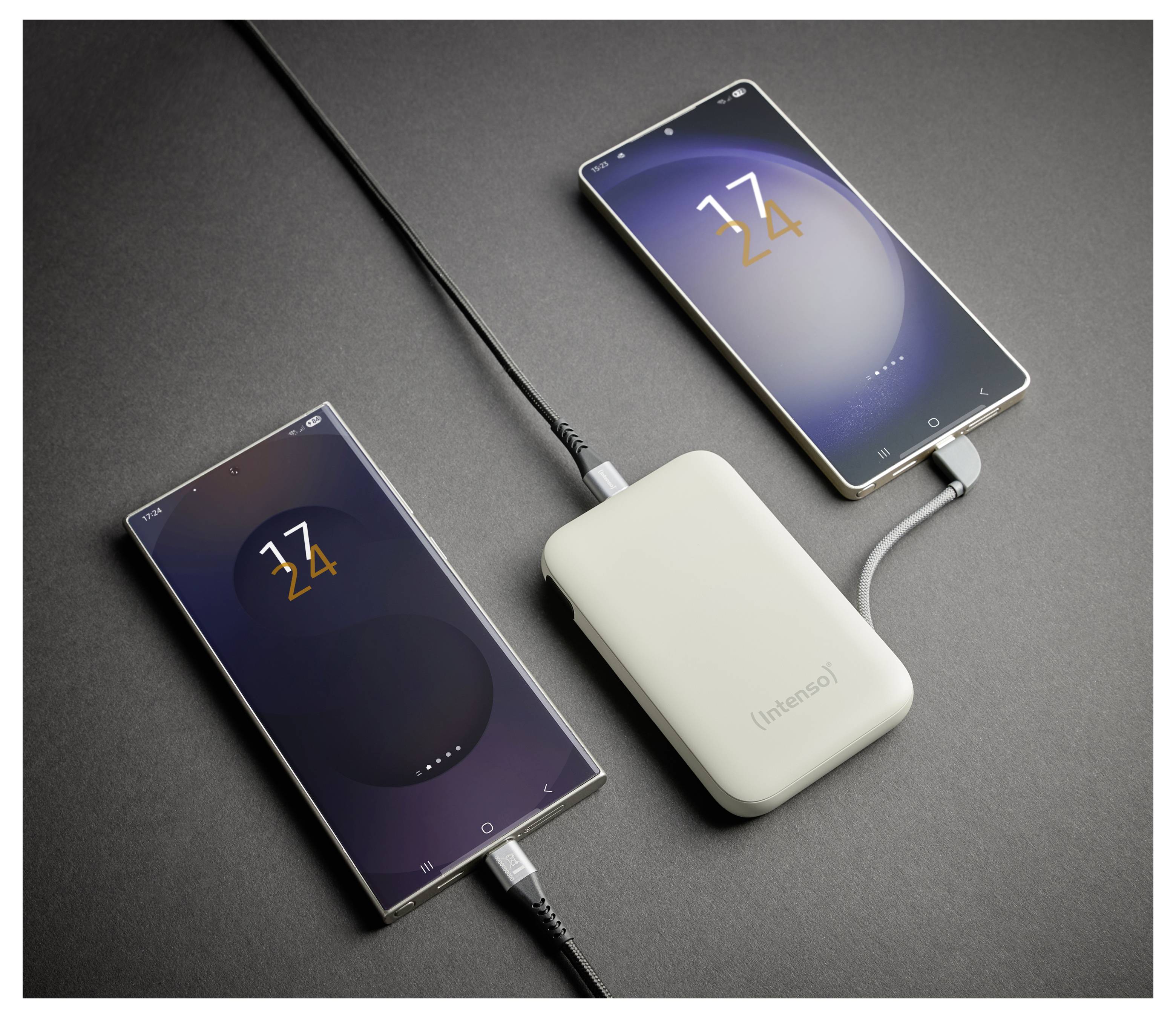 A white power bank charging two smartphones, both displaying '24%' battery level, connected with black cables on a gray surface.