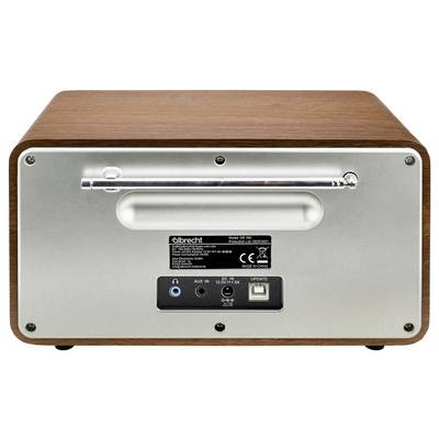 The image shows the back of a retro-style radio with a wooden finish, featuring audio input ports, a power input, and a control label.