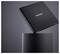 A black Intenso external hard drive hovers over a cylindrical black pedestal, showcasing its sleek and minimalist design.