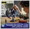 'A person assembling a detailed Bat-Signal model from 678 pieces, suitable for ages 12 and up. Official DC Batman merchandise.'