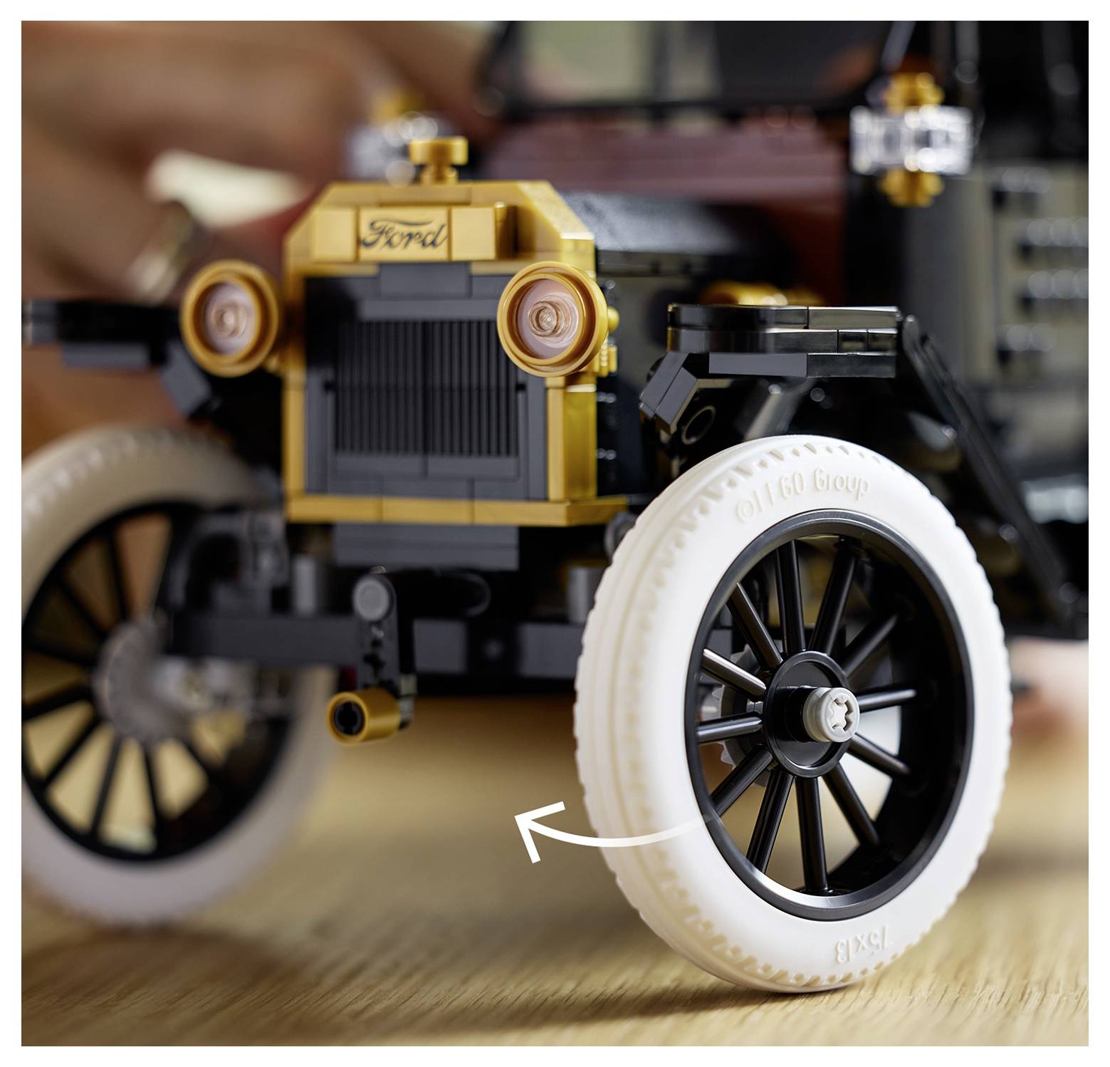 Close-up of a vintage-style Lego car, focusing on the detailed front grill and wheels.