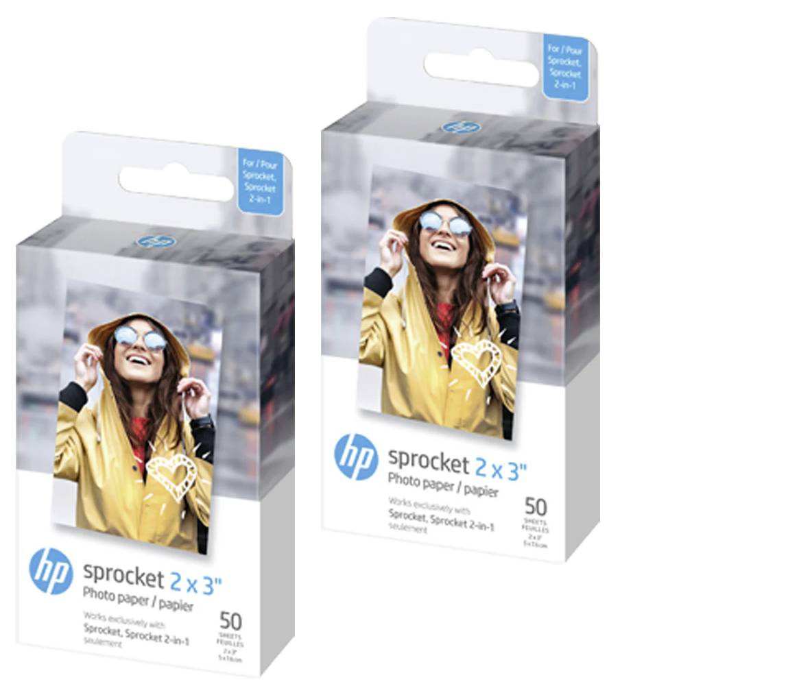 Two boxes of 'HP Sprocket 2x3" Photo Paper', each containing 50 sheets. The packaging shows a smiling person wearing sunglasses.