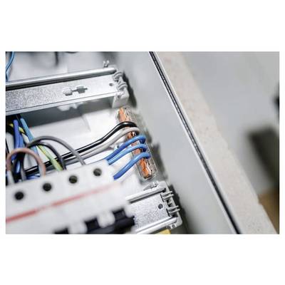 Close-up of electrical wiring inside a control panel, with blue, black, and green wires connected to metal terminals.<br>
