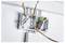 Open electrical junction boxes with exposed multicolored wires and a coiled wire connector mounted on a white wall.