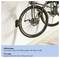 Bicycle mounted on a wall with a tire stop to prevent the tire from hitting the wall.