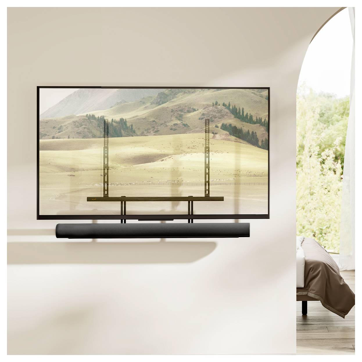 A large flat-screen TV displays a scenic landscape with hills and trees. A soundbar is mounted directly below the TV.