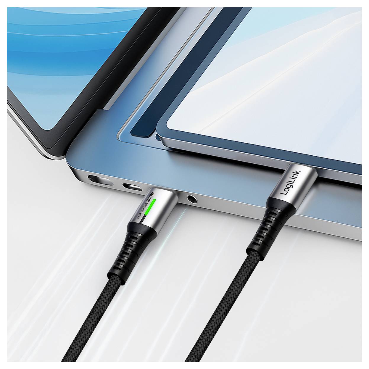 Two laptops are connected using metallic braided cables plugged into USB-C ports. One port has a green light indicator.