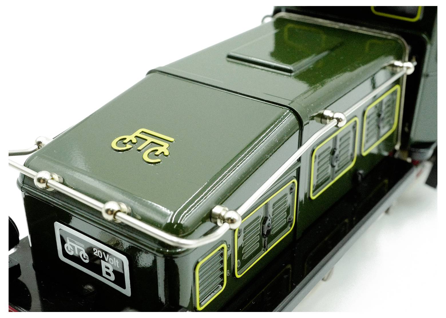 A dark green vehicle model with yellow 'ETC' logo and decorative railings, designed to resemble a vintage mode of transport.