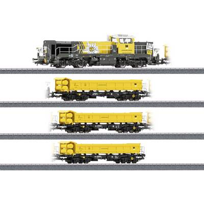A yellow and gray locomotive with three yellow freight cars on separate tracks, branded with 'LTE' and an edelweiss flower logo.