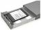 An open hard drive enclosure with a visible internal solid-state drive (SSD), showing connectors and circuitry.