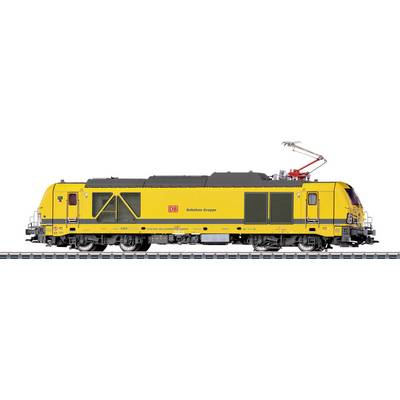 A yellow train engine branded with 'DB Bahnbau Gruppe' on a track with pantograph extended, typically used for railway construction work.