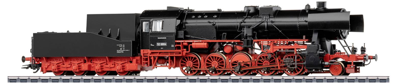 A model of a black and red steam locomotive on display, showing intricate detailing of wheels and machinery.