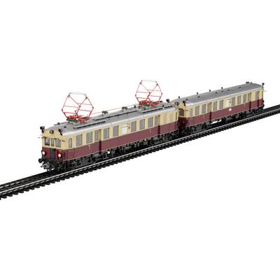 A model train set featuring two vintage electric locomotives with a beige and red color scheme on display tracks.