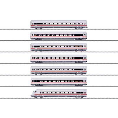 Five model train cars lined up vertically on parallel tracks; each car is white with red and grey details, showcasing different designs.