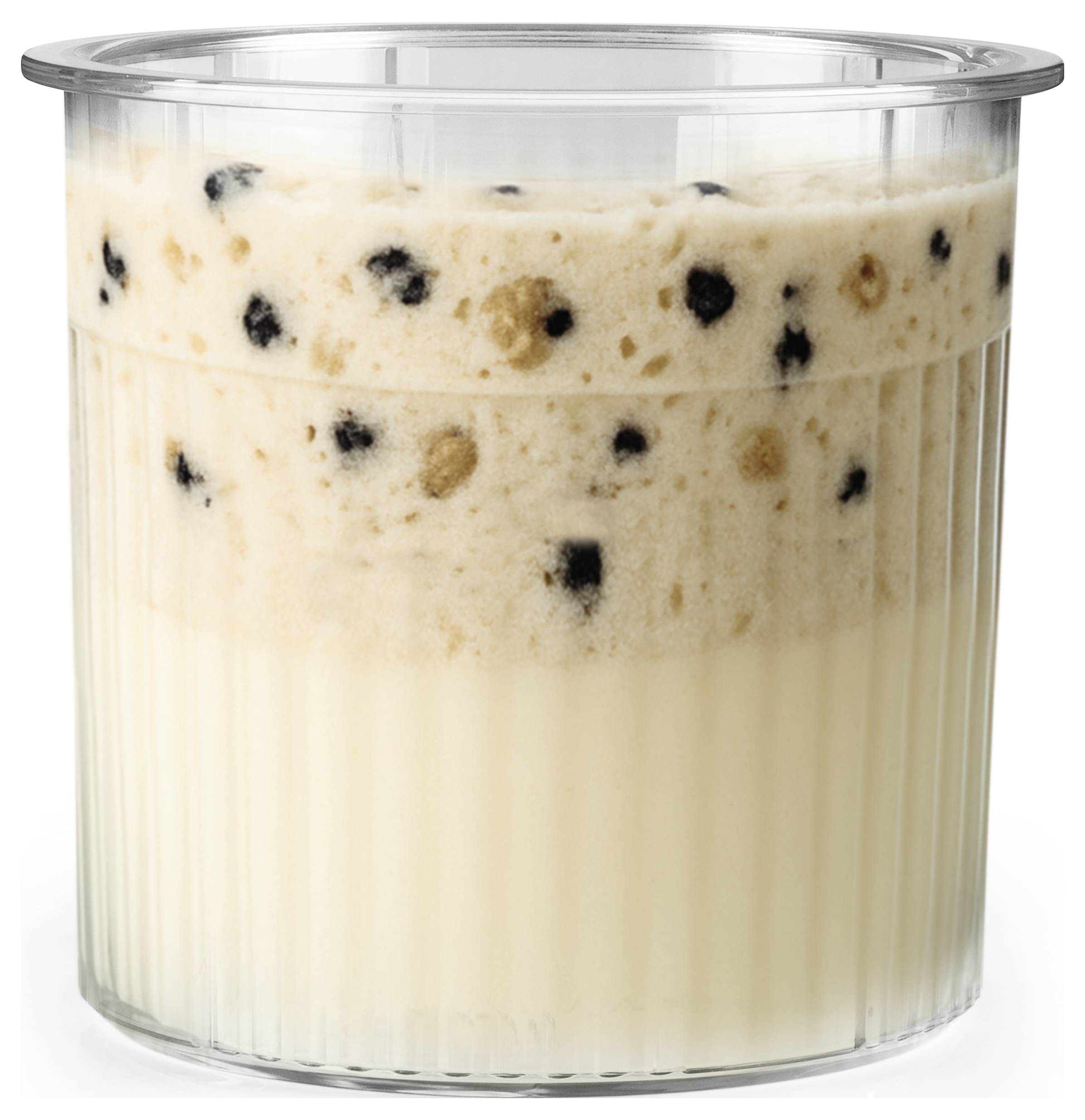 A clear cup filled with creamy, frothy yellow liquid topped with a thicker layer containing brown and black specks.