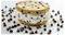 Chocolate chip cookie ice cream sandwich on a white background, surrounded by scattered chocolate chips.