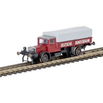 A miniature model of a vintage red and black truck on a railway track, marked 'Deutsche Bundesbahn', with a light gray cover on the back.