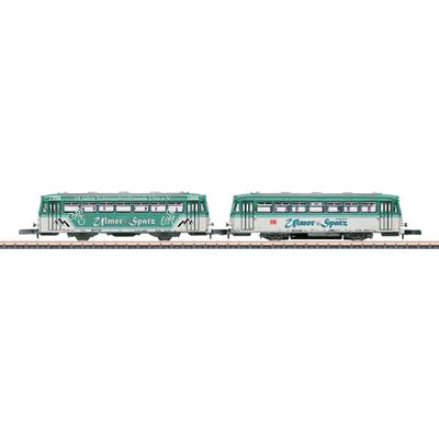 Two green and white vintage-style electric streetcars on tracks, with 'Nature-Spots' written on the sides, showcasing a retro design.