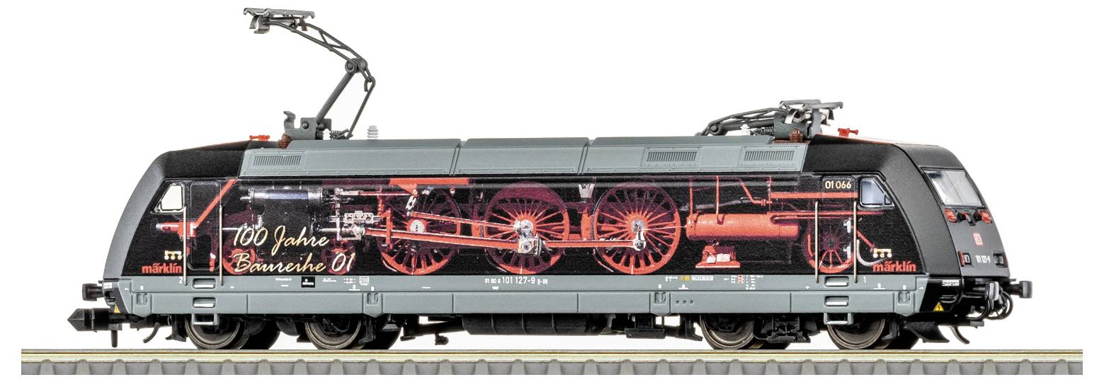 A model train locomotive with detailed artwork commemorating 100 years of the BR 01 steam locomotive, showcasing mechanical components.