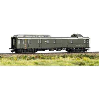 'A model train car in green with detailed markings sits on a rail track, surrounded by grass, showcasing fine craftsmanship.'