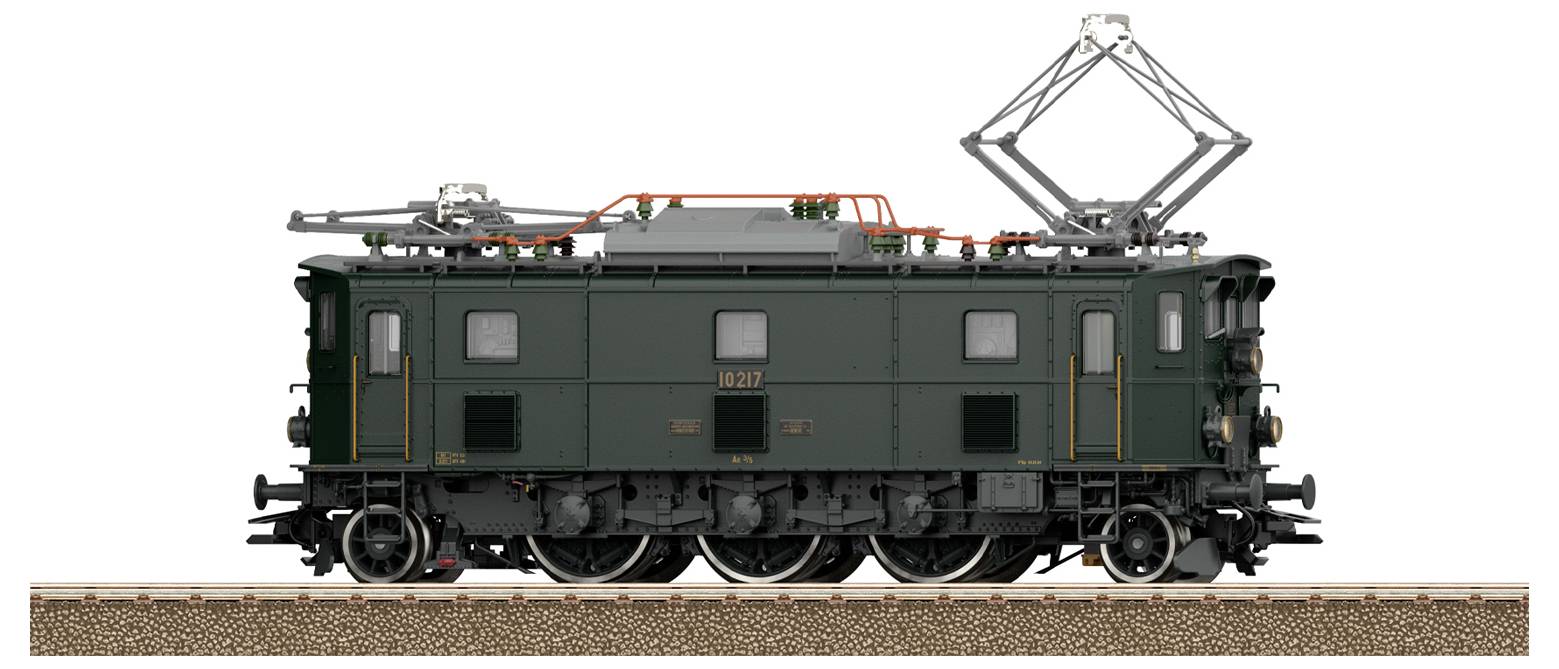 A detailed model of a vintage green electric train with visible wheels and overhead power structures, resting on a textured track.