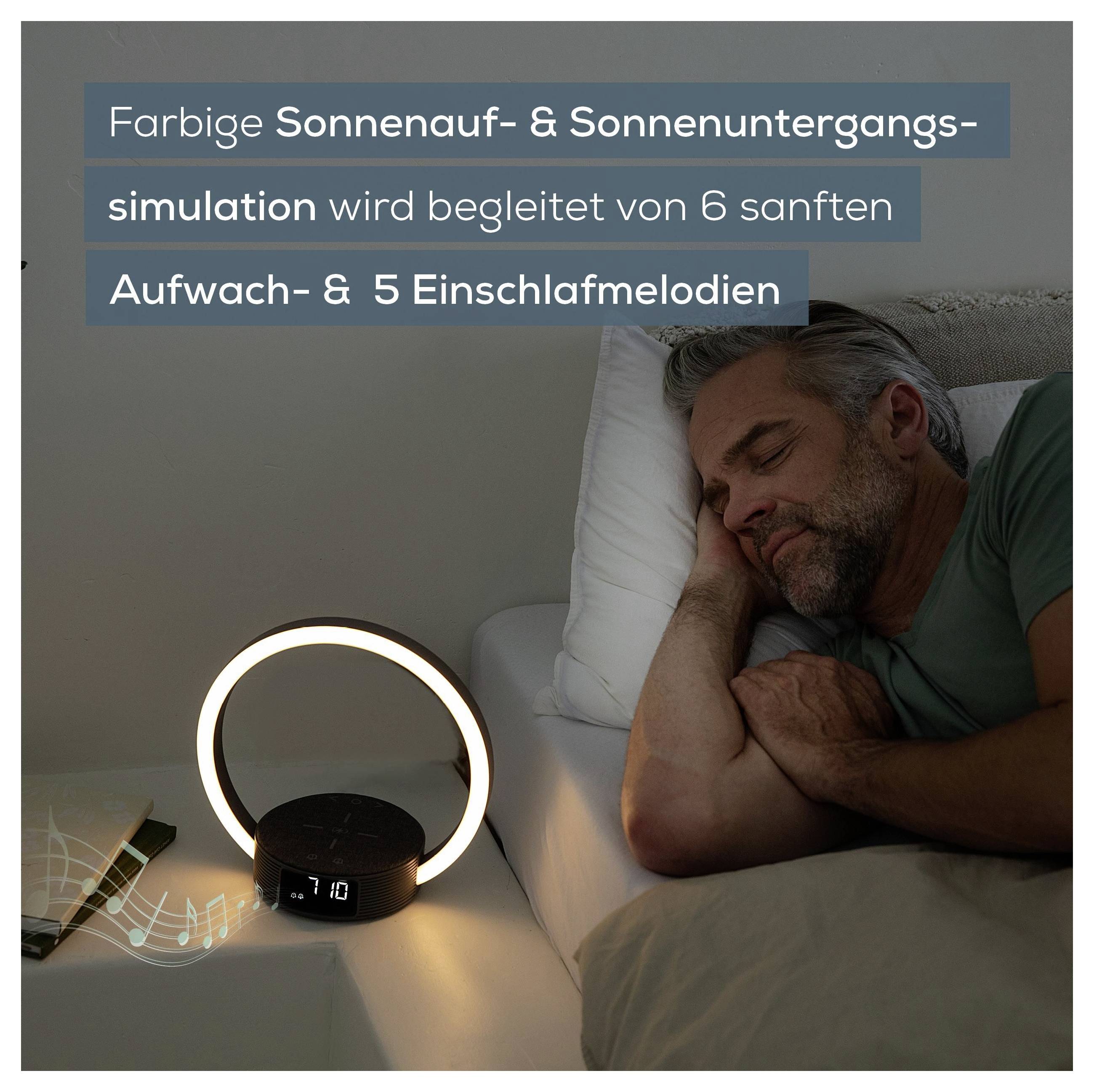 Man sleeping peacefully with a sunrise simulation lamp showing the time '10:10'. Accompanied by text about sunset and sunrise simulation.