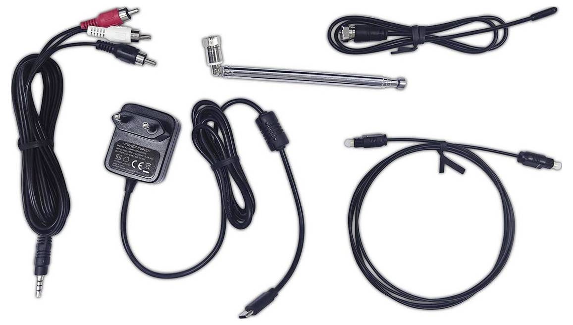 Assorted cables and connectors laid out, including audio and power cables, a metal antenna, and a power adapter.