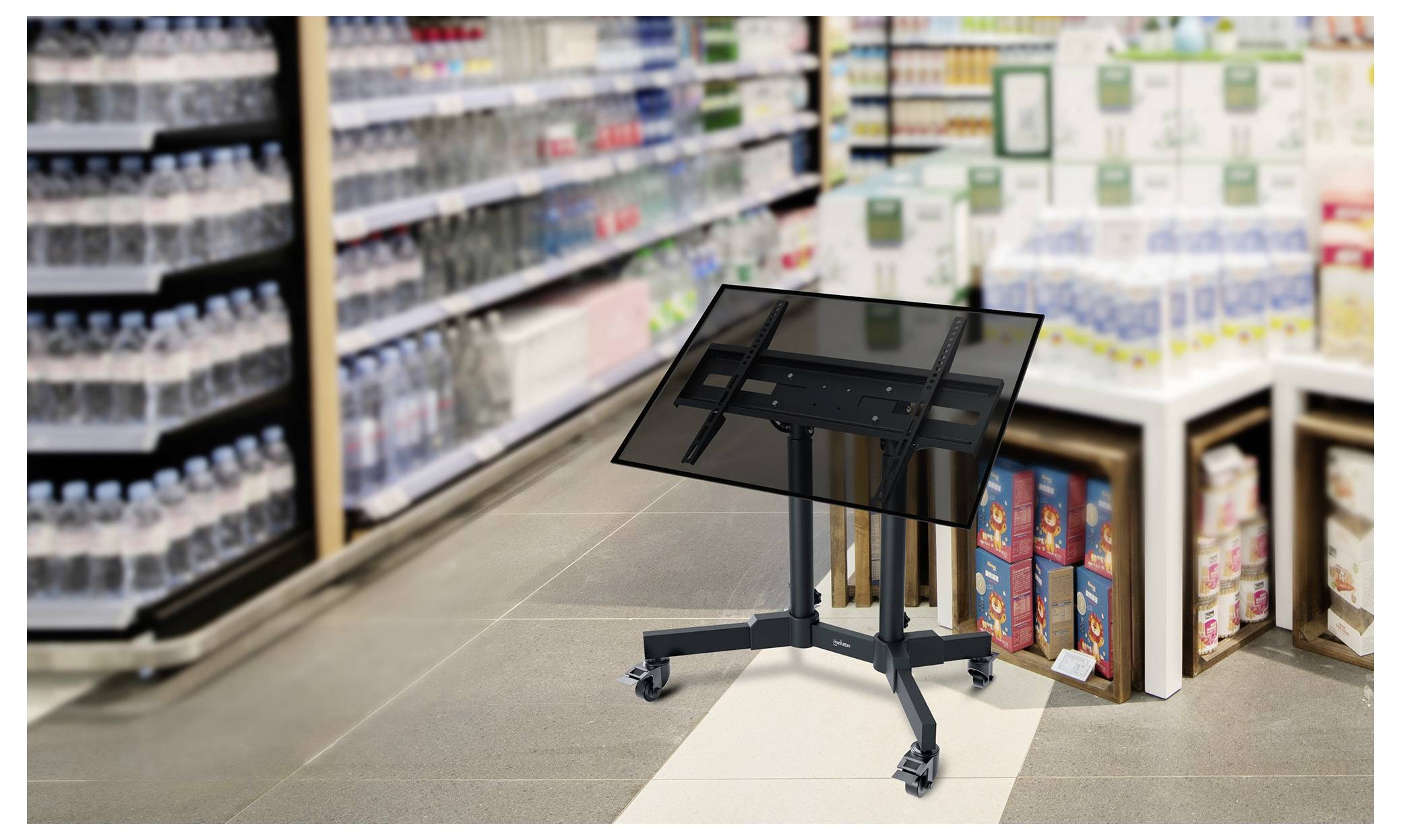 A tilted rectangular black display stand with wheels is in the center of a grocery aisle, surrounded by shelves with bottled water and other products.