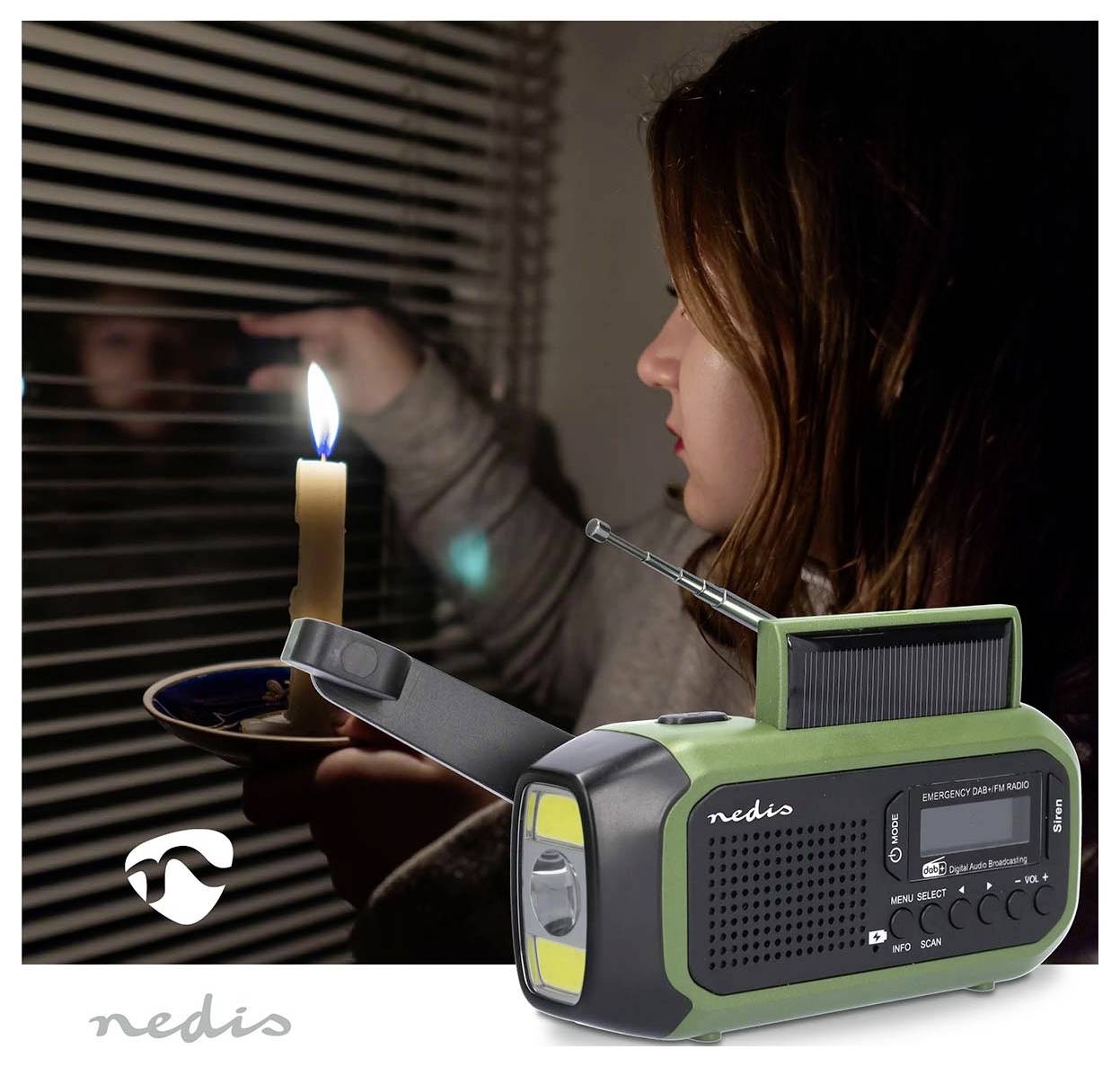 A woman holds a candle by a window in the dark. In the foreground, a green emergency radio is shown, suggesting preparedness.