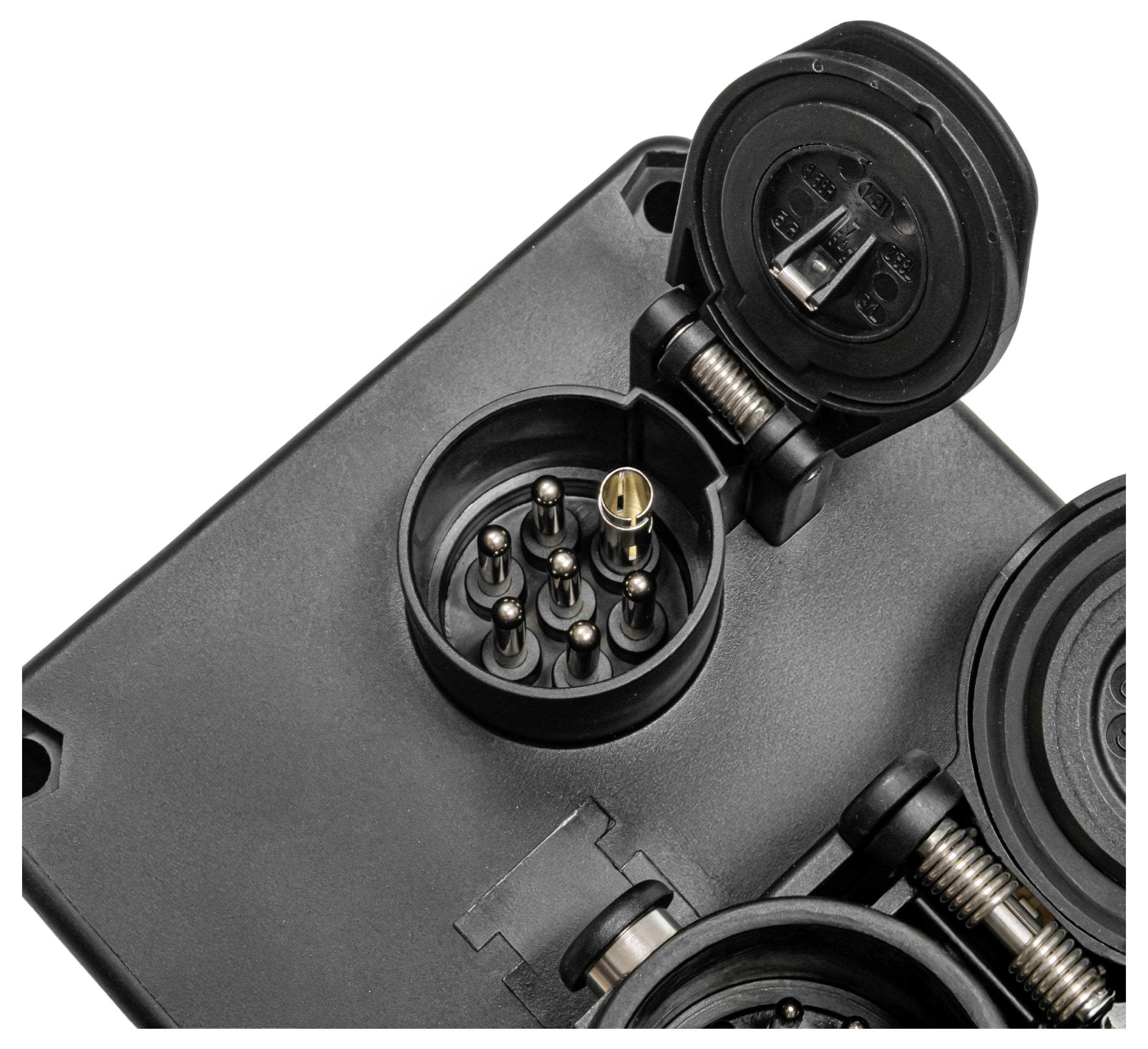 'A close-up of a round electrical connector with multiple pins on a black casing, featuring open protective covers with hinges.'