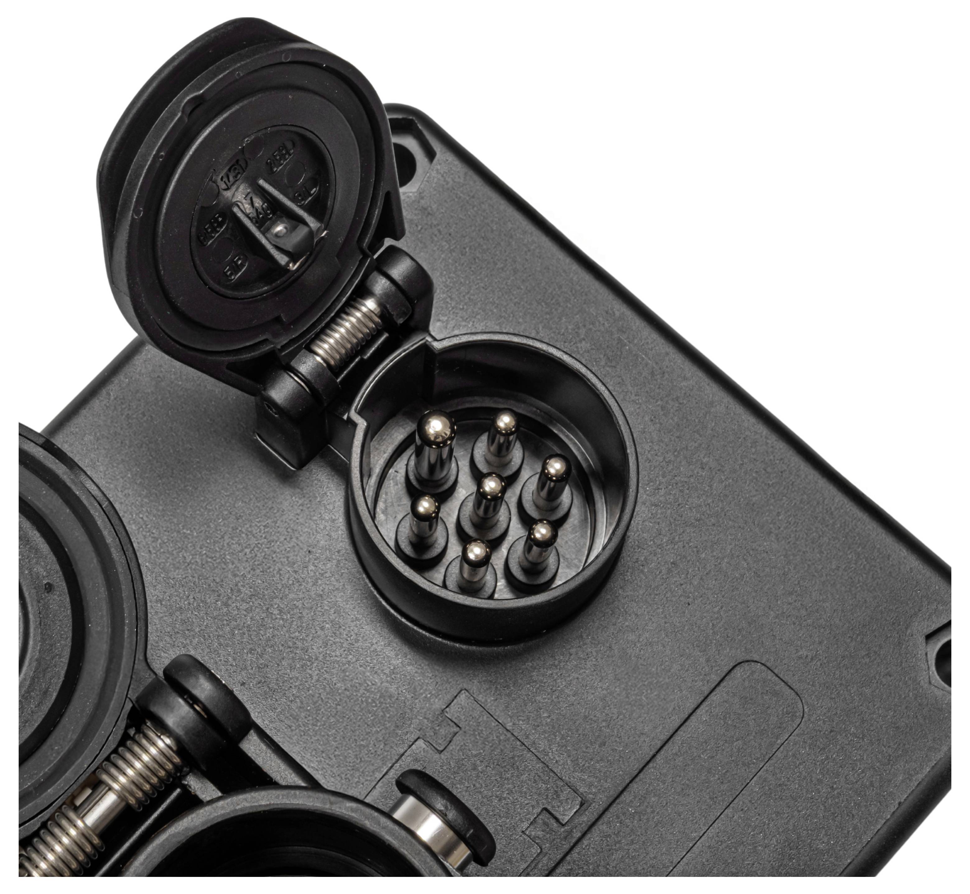 'Close-up of a trailer socket with seven pins, used for connecting electrical circuits between a towing vehicle and a trailer.'