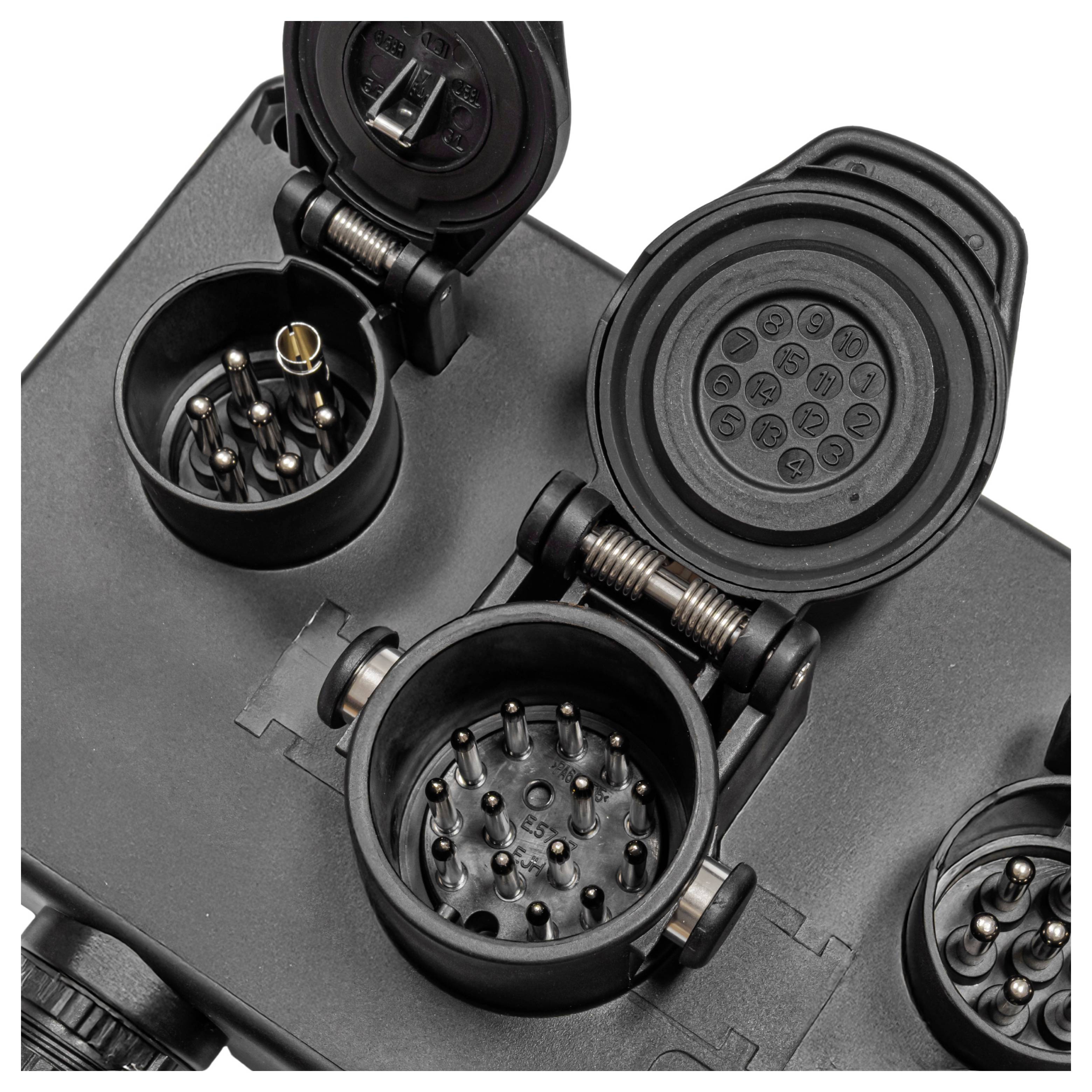 'Close-up of an automotive trailer connector socket with open covers, revealing pin configurations for electrical connections.'