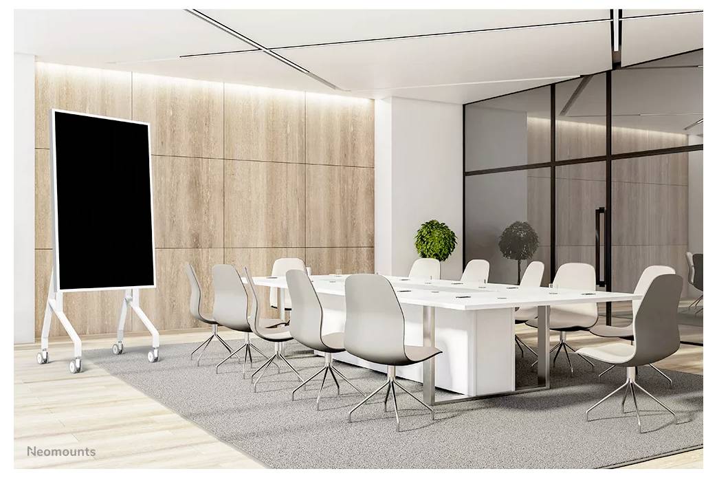 A modern conference room with a large table, surrounded by white chairs, a wheeled blackboard, and natural wooden accent walls.