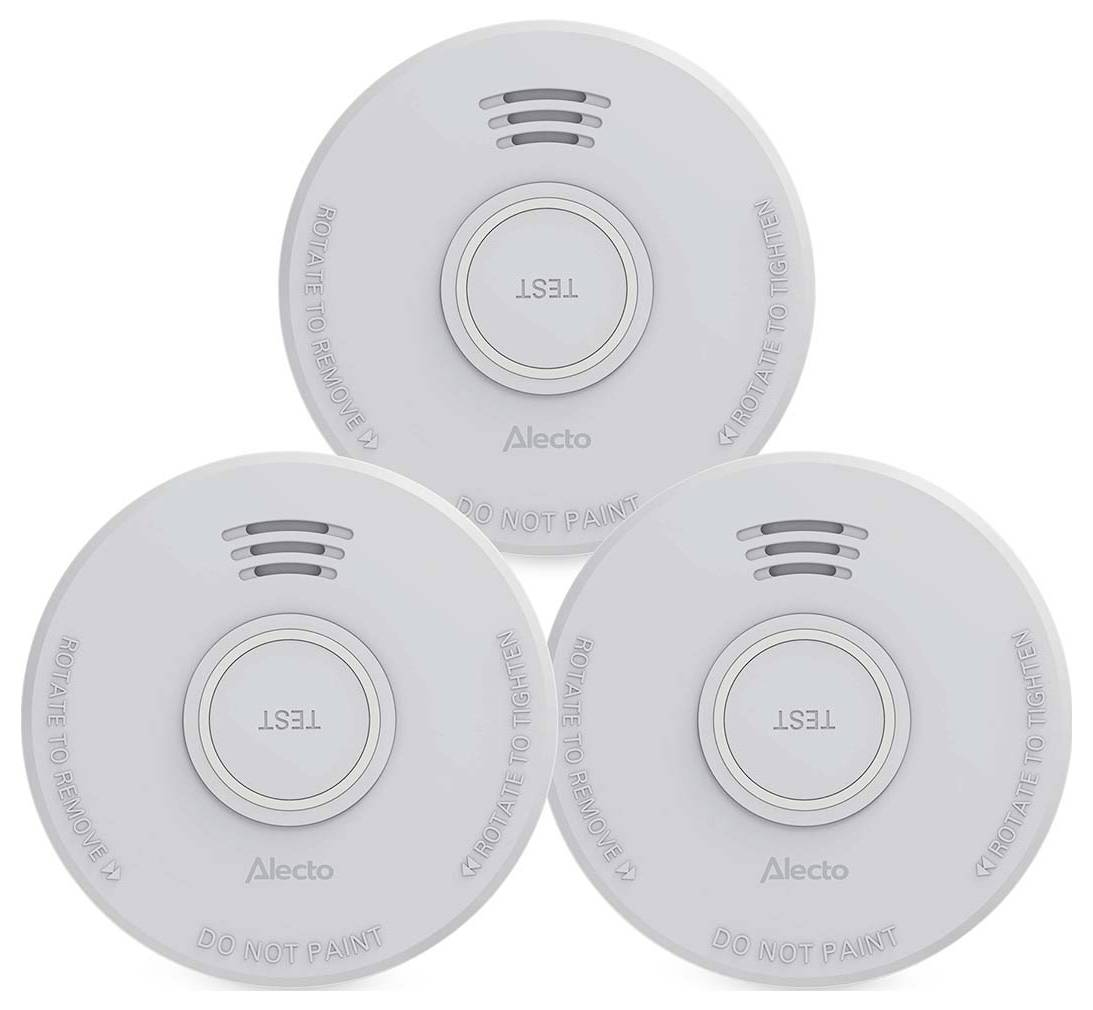 'Three round, white smoke detectors with a central button labeled "Test". Each unit has ventilation slots and safety warnings.'