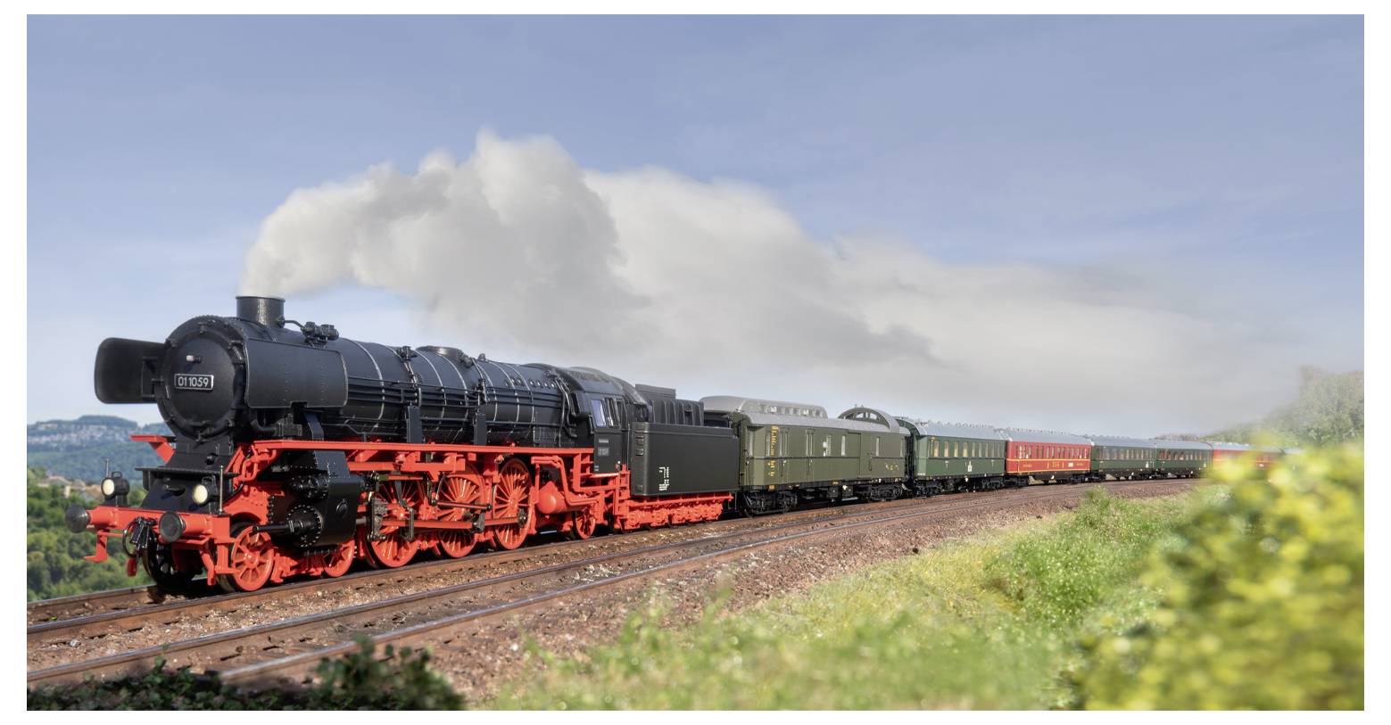 A vintage steam locomotive with red wheels pulls a passenger train through a scenic landscape, emitting white smoke from its chimney.