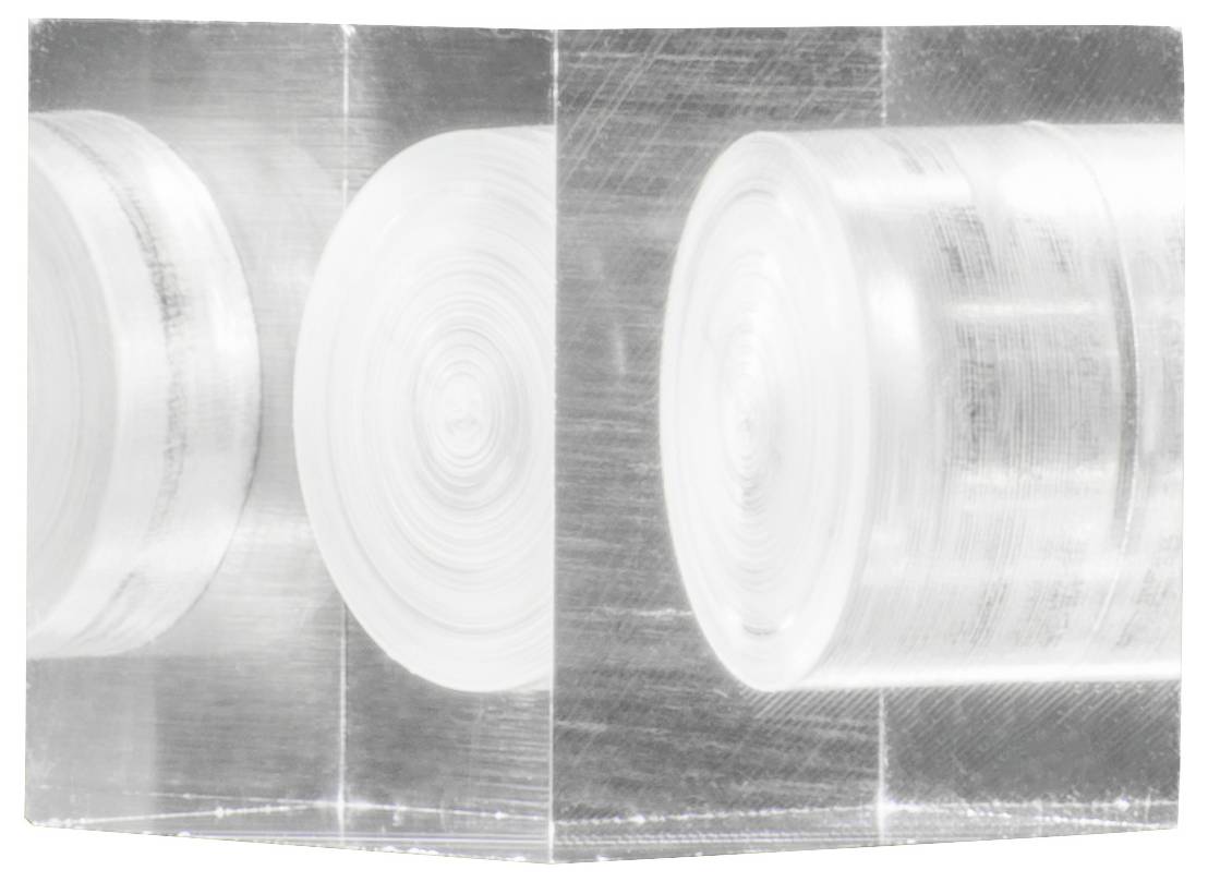 'Acrylic block containing multiple round, carefully arranged layers face-to-face on two sides for abstract aesthetic effect.'