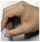 A hand holding a small, transparent cube with a circular indentation, positioned against a plain background.