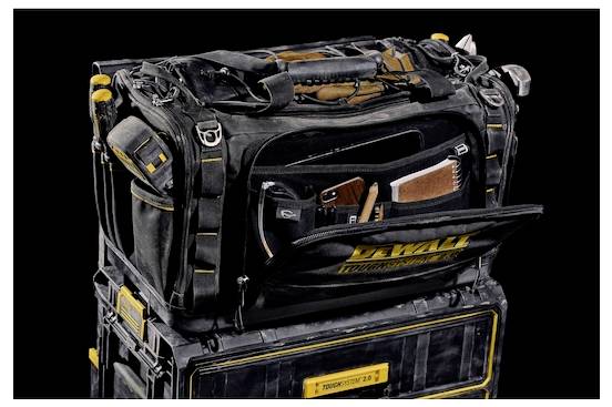 A black and yellow tool bag with multiple compartments, containing various tools like a hammer and wrench, placed on a stack of toolboxes.