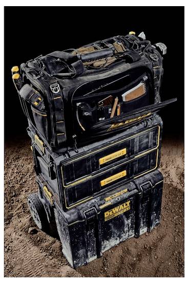 A stack of black DeWalt toolboxes with yellow accents on a dirt background, highlighting portability and durability for construction work.