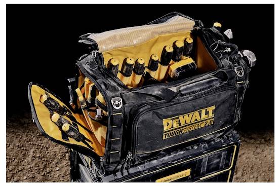 A DeWalt ToughSystem 2.0 tool bag is open, revealing an assortment of tools inside, set on a rough surface, highlighting durability.