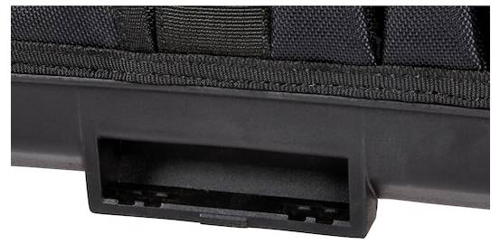 A close-up of a black fabric and plastic latch or clip, possibly part of a bag or case.