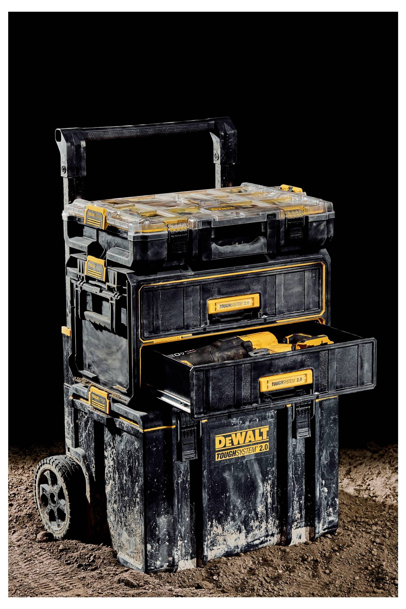 A stacked tool chest with wheels and multiple compartments, labeled 'TOUGHSYSTEM', on a dark background.