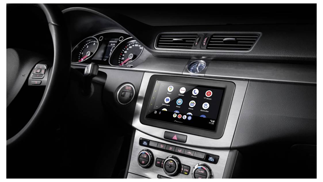 Car dashboard showing a touchscreen display with various app icons, indicating a modern vehicle infotainment system.