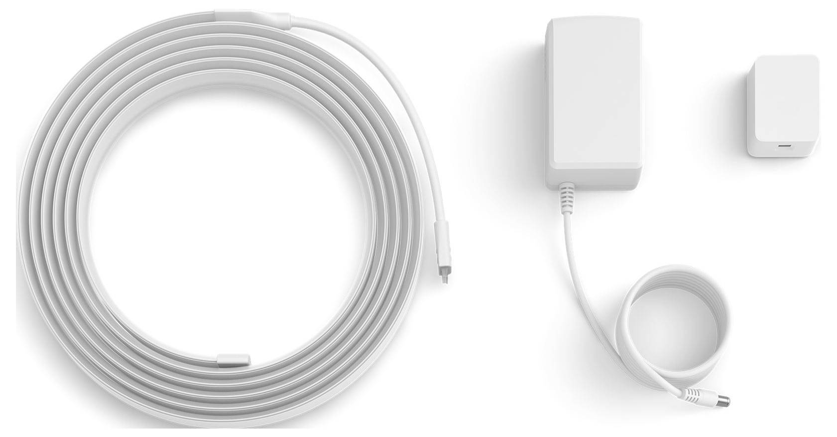 A white networking device with a long coiled cable, a power adapter, and a smaller attachment, all laid out on a white background.