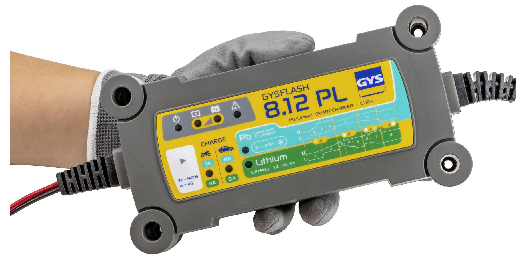 A person wearing a glove holds a GYSFLASH 8.12 PL battery charger labeled with charging modes and battery type indications.