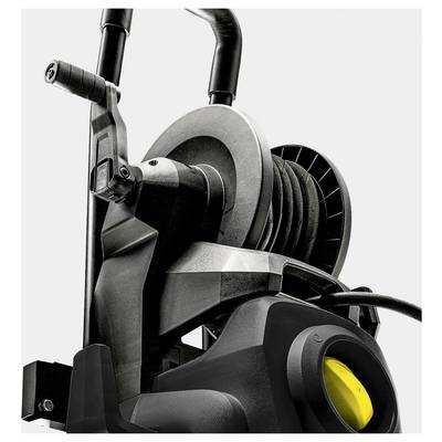 A close-up of a pressure washer, focusing on the hose reel and handle, highlighting mechanical parts and the sturdy design.