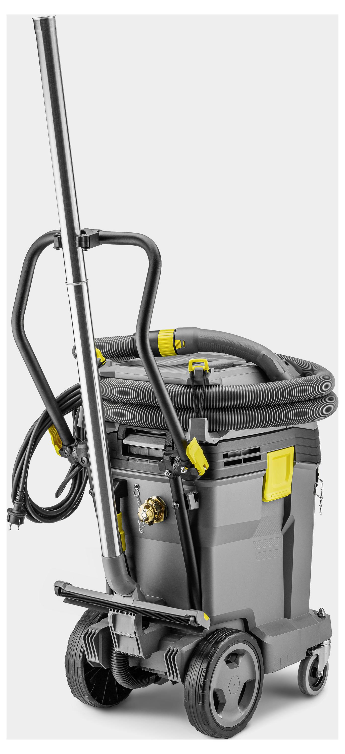 A compact grey and yellow commercial vacuum cleaner with wheels, a long handle, and a coiled hose on top, designed for efficiency.