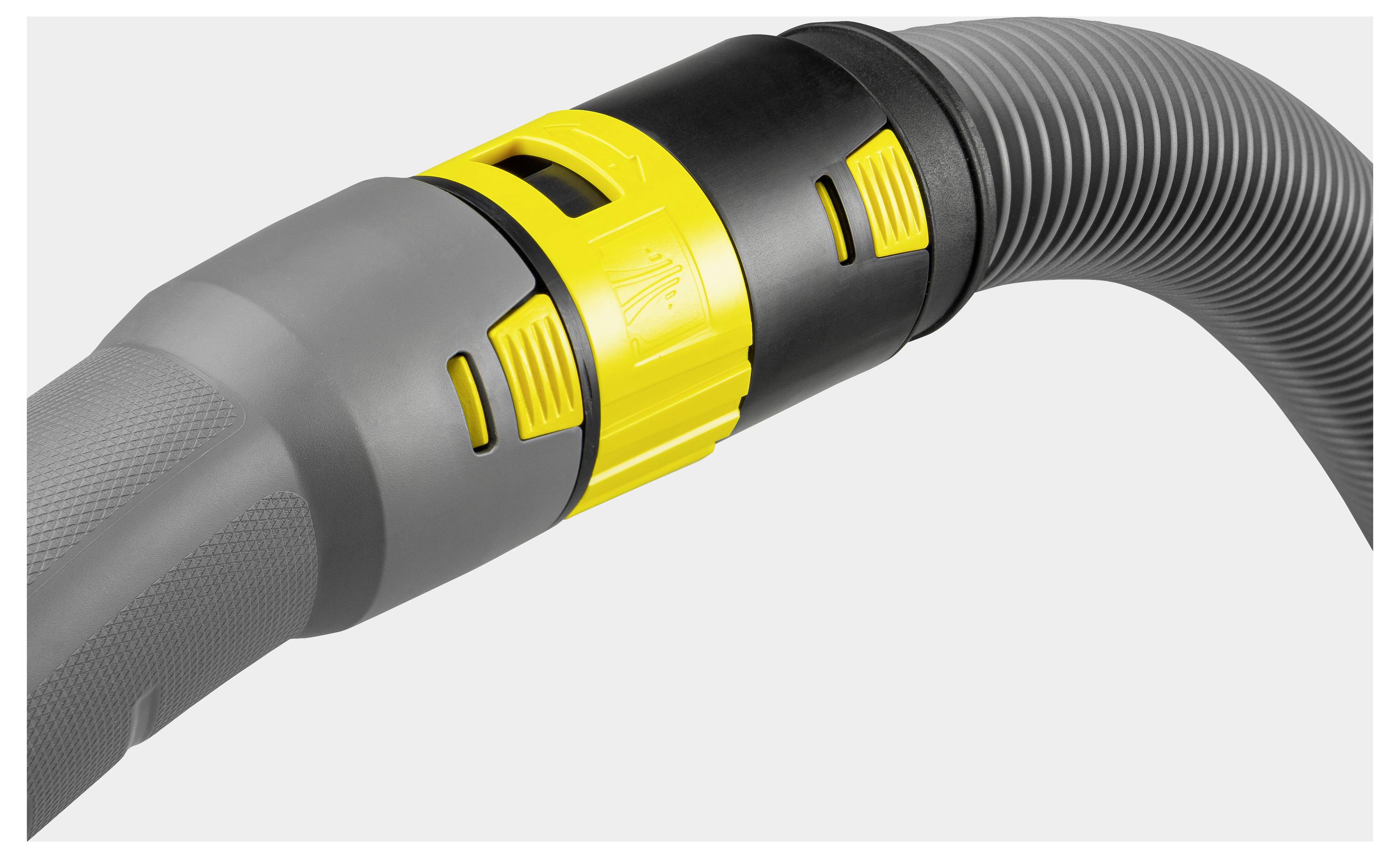 A close-up of a vacuum cleaner hose shows a yellow and black adjustable nozzle with a textured gray handle, illustrating its grip and functionality.